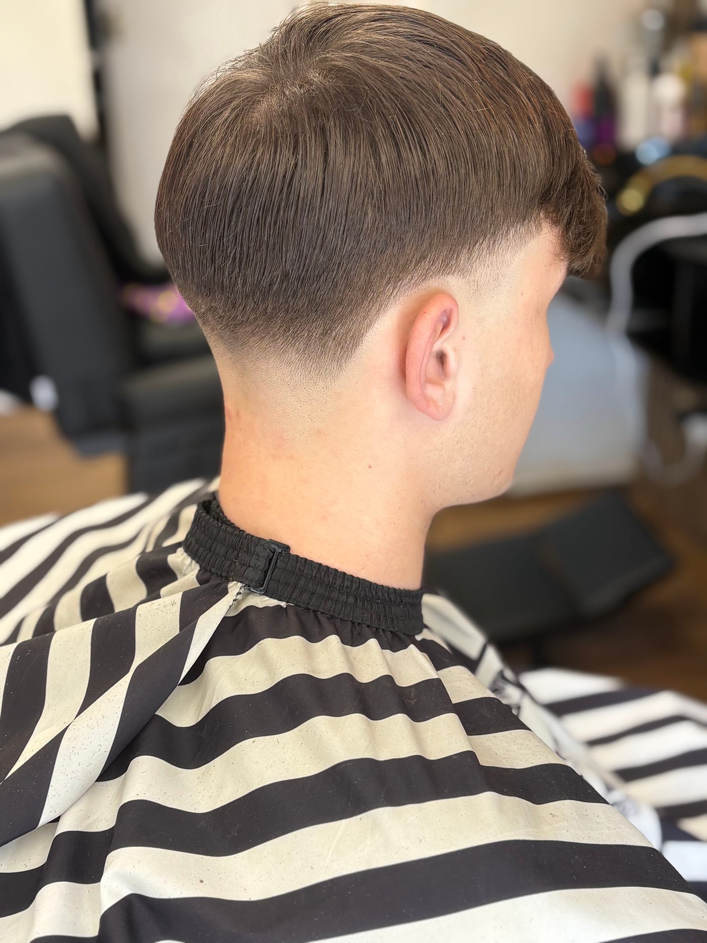 Neatly tapered haircut photographed from the back in the Onyx chair