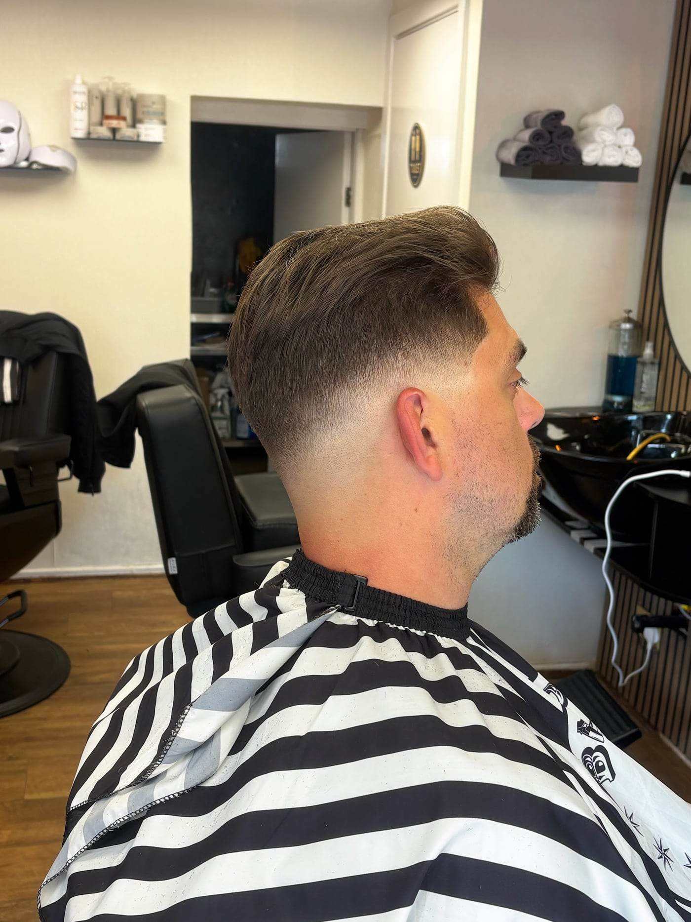 Finished short haircut with a side fade, photographed inside Onyx Barbershop